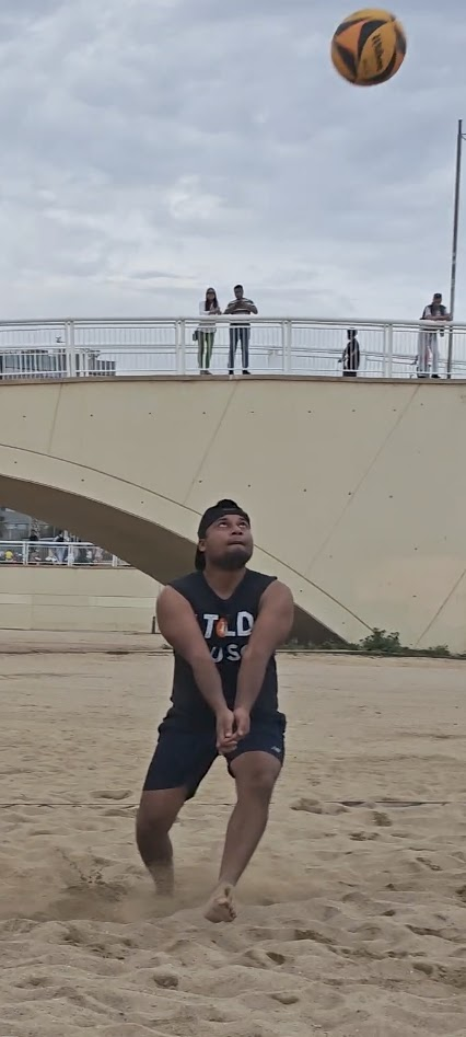 Jimmy Humania bumping a volleyball on the beach in Spain
